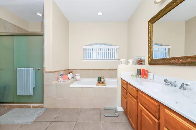 a spacious bedroom with a bed dresser and a window