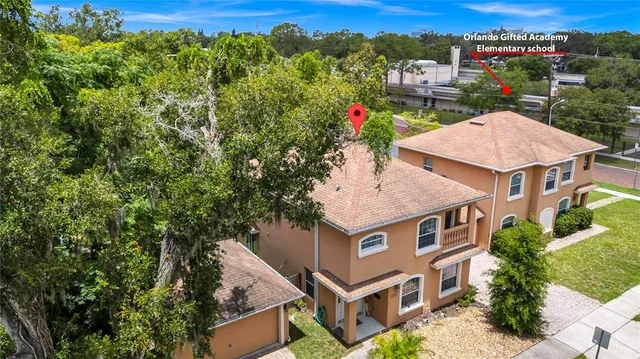 an aerial view of multiple houses with a yard