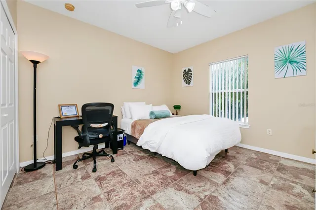 a bedroom with a bed and a desk