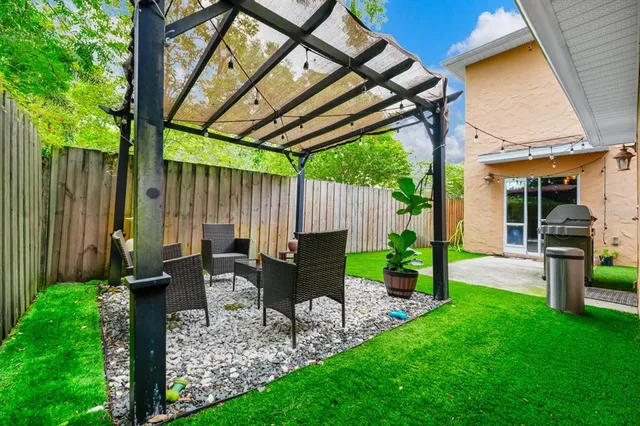 a view of a house with a yard and sitting area