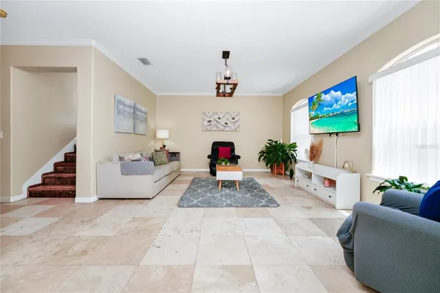 a living room with furniture and a flat screen tv