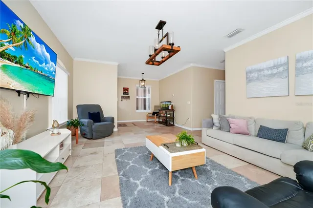 a living room with furniture a rug and a window