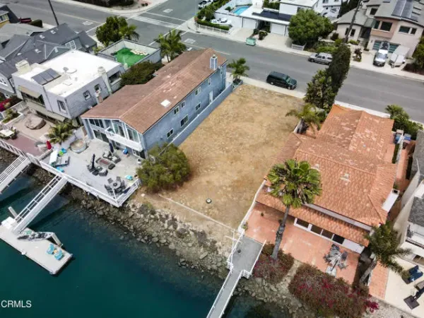 an aerial view of multiple houses with yard