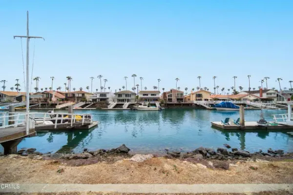 a view of a lake with boats and trees in the background