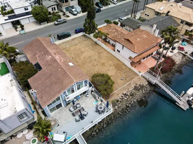 an aerial view of a house with a lake