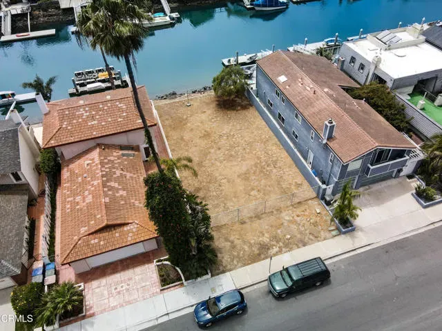 an aerial view of a house with a yard and lake view