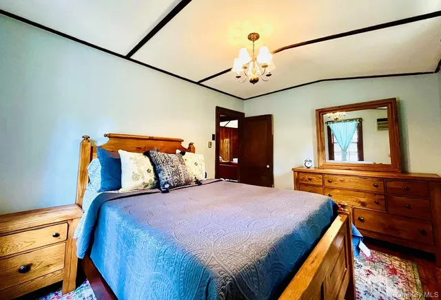 a bedroom with a bed and a chandelier