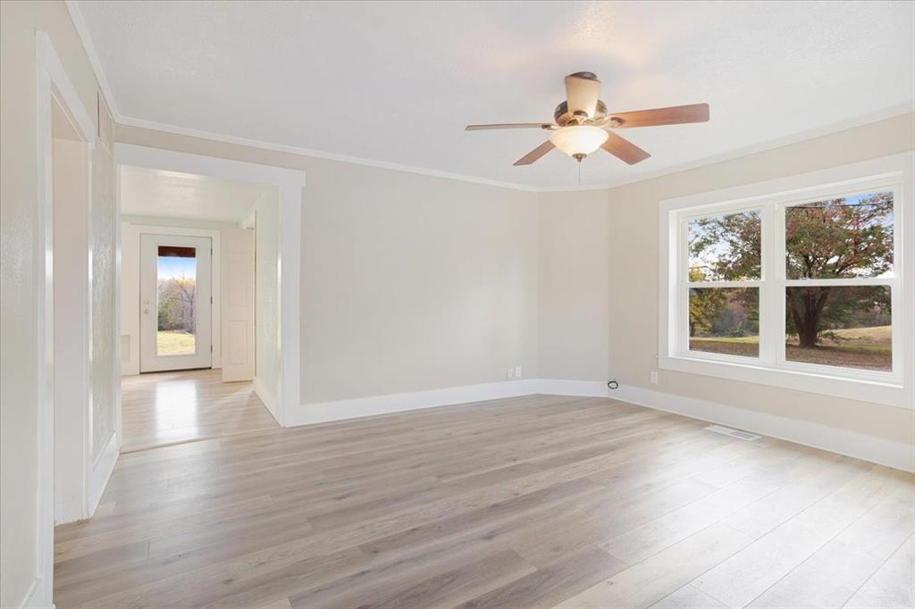 40 Sheryl Lane Denison, TX 75021 - Photo 15 of 40 wooden floor in an empty room with a window