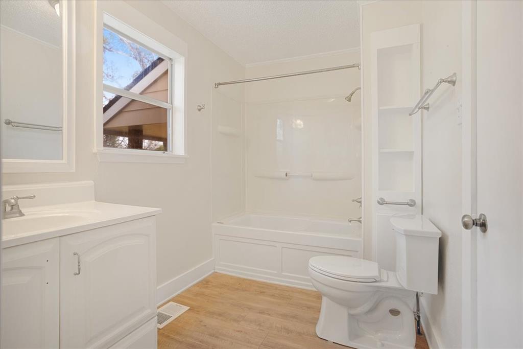 40 Sheryl Lane Denison, TX 75021 - Photo 31 of 40 a bathroom with a toilet a sink and bath tub