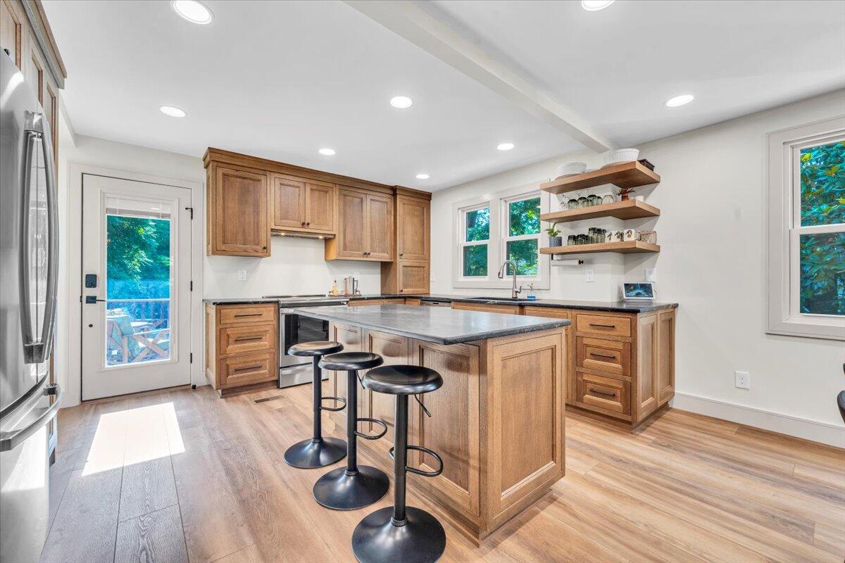 3007 Green Ridge Road Roanoke, VA 24019 - Photo 10 of 56 a kitchen with stainless steel appliances granite countertop a stove top oven a sink and white cabinets with wooden floor
