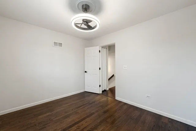 an empty room with wooden floor