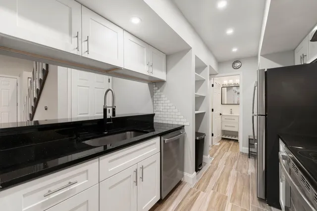 a kitchen with stainless steel appliances a sink stove and refrigerator