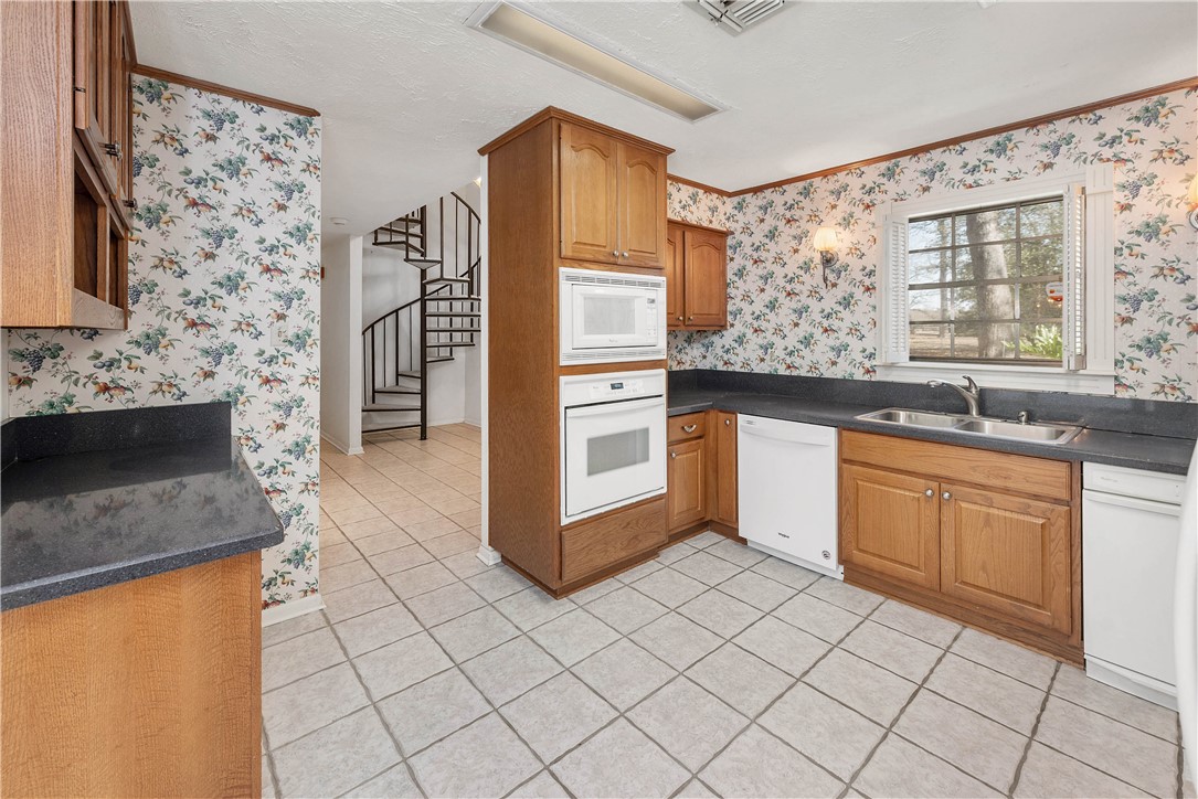 12994 Hunters Creek Road College Station, TX 77845 - Photo 12 of 35 a kitchen with stainless steel appliances granite countertop a sink and a stove