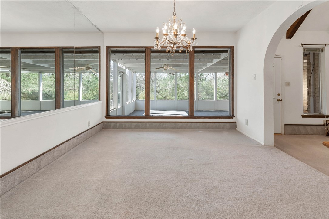 12994 Hunters Creek Road College Station, TX 77845 - Photo 13 of 35 a view of a big room with windows and chandelier