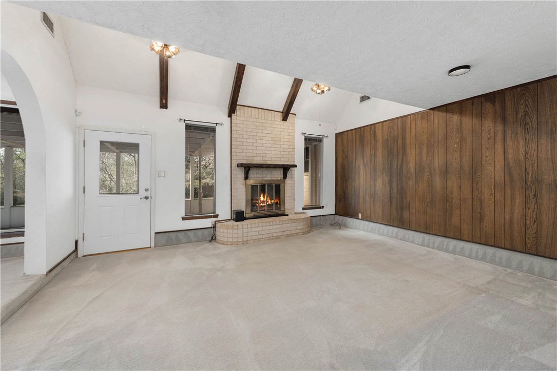 12994 Hunters Creek Road College Station, TX 77845 - Photo 15 of 35 an empty room with furniture and a fireplace