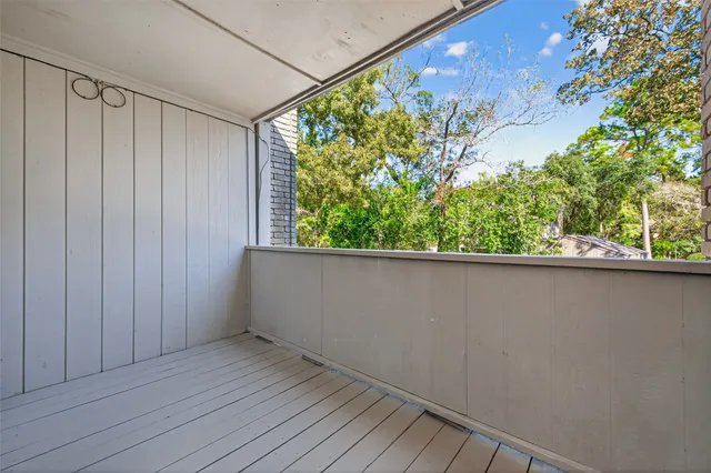 a view of a balcony with wooden floor and plant