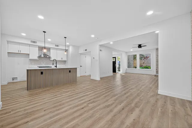 a view of kitchen with kitchen island wooden cabinets and stainless steel appliances