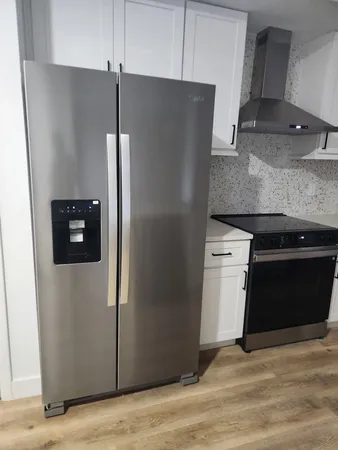 a kitchen with metallic refrigerator freezer and a dishwasher