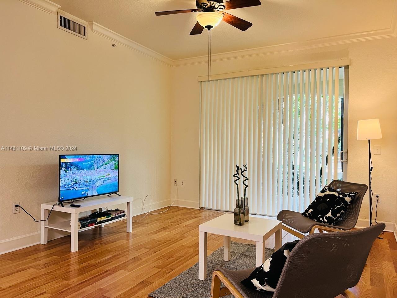 1121 Renaissance Way, Unit 1121 Boynton Beach, FL 33426 - Photo 11 of 29 a living room with furniture and a flat screen tv