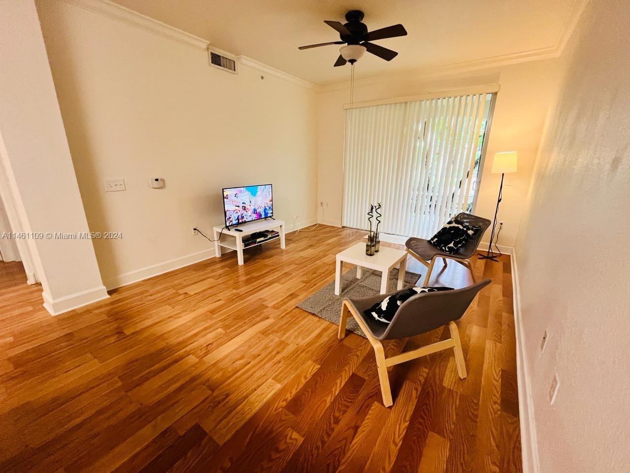 1121 Renaissance Way, Unit 1121 Boynton Beach, FL 33426 - Photo 12 of 29 a living room with furniture and a wooden floor