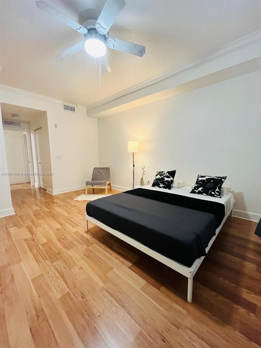 1121 Renaissance Way, Unit 1121 Boynton Beach, FL 33426 - Photo 23 of 29 a bedroom with a bed and a ceiling fan
