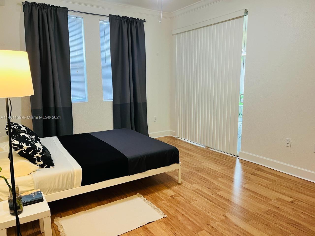 1121 Renaissance Way, Unit 1121 Boynton Beach, FL 33426 - Photo 28 of 29 a bedroom with a bed and wooden floor