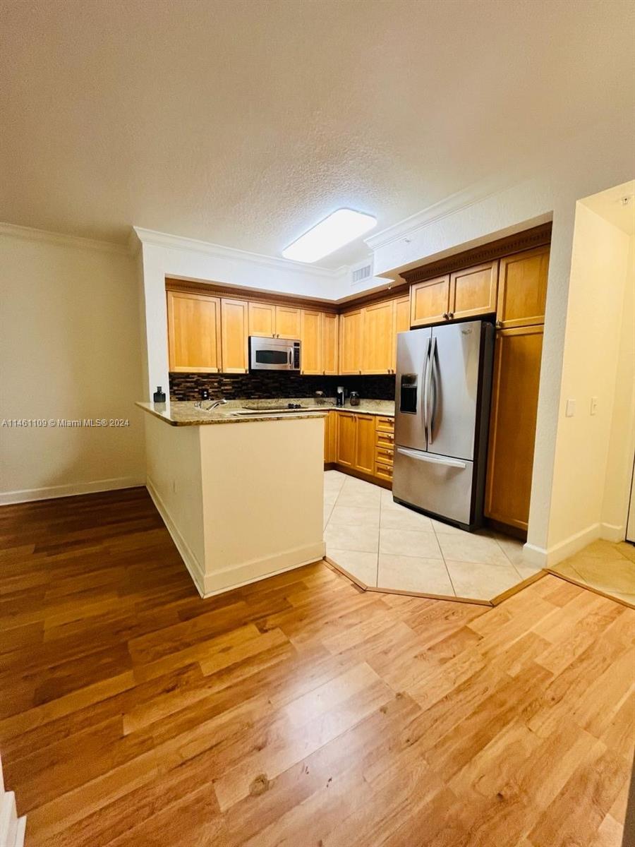 1121 Renaissance Way, Unit 1121 Boynton Beach, FL 33426 - Photo 4 of 29 a view of a kitchen with wooden floor