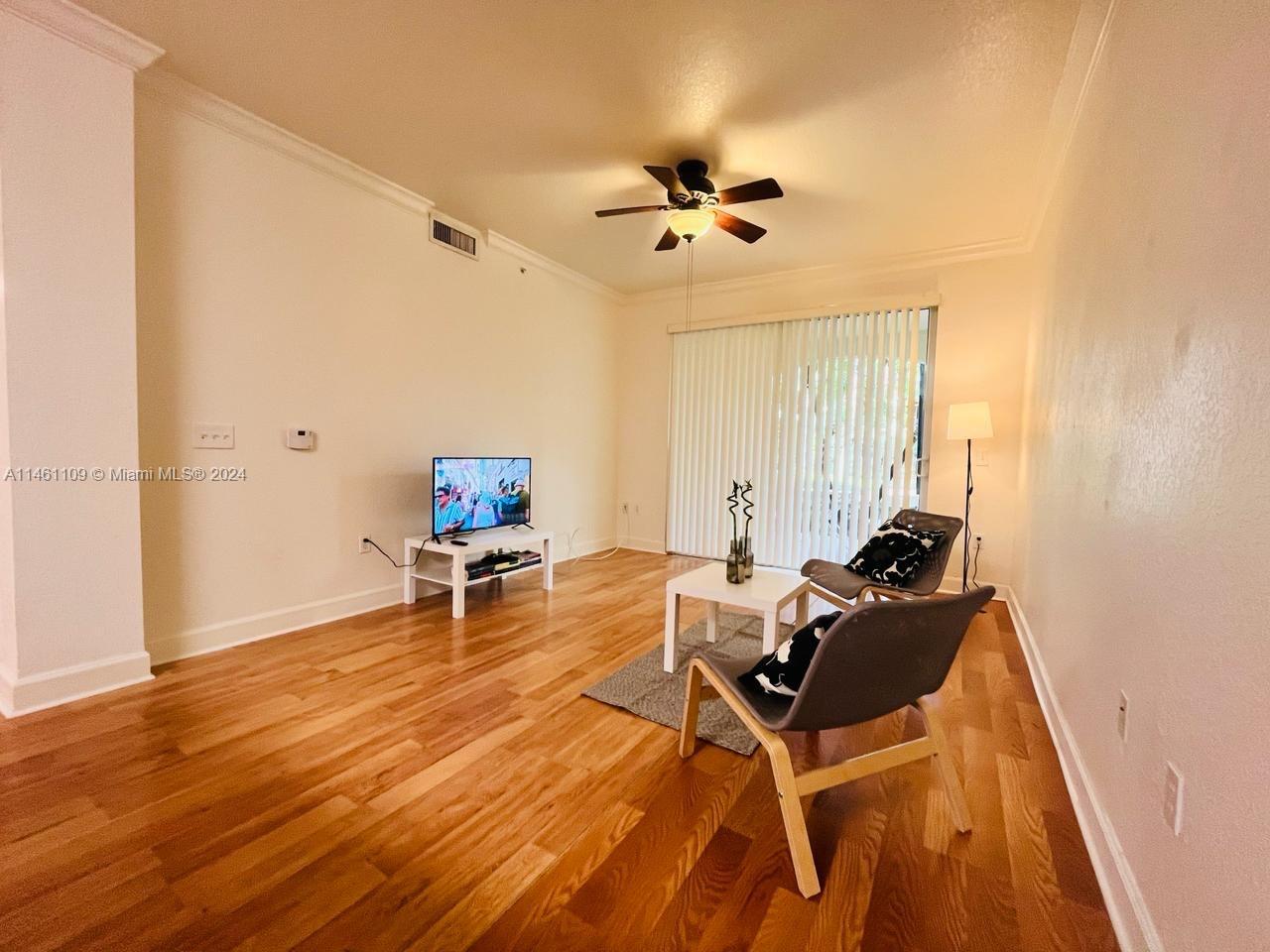 1121 Renaissance Way, Unit 1121 Boynton Beach, FL 33426 - Photo 7 of 29 a living room with furniture and a wooden floor