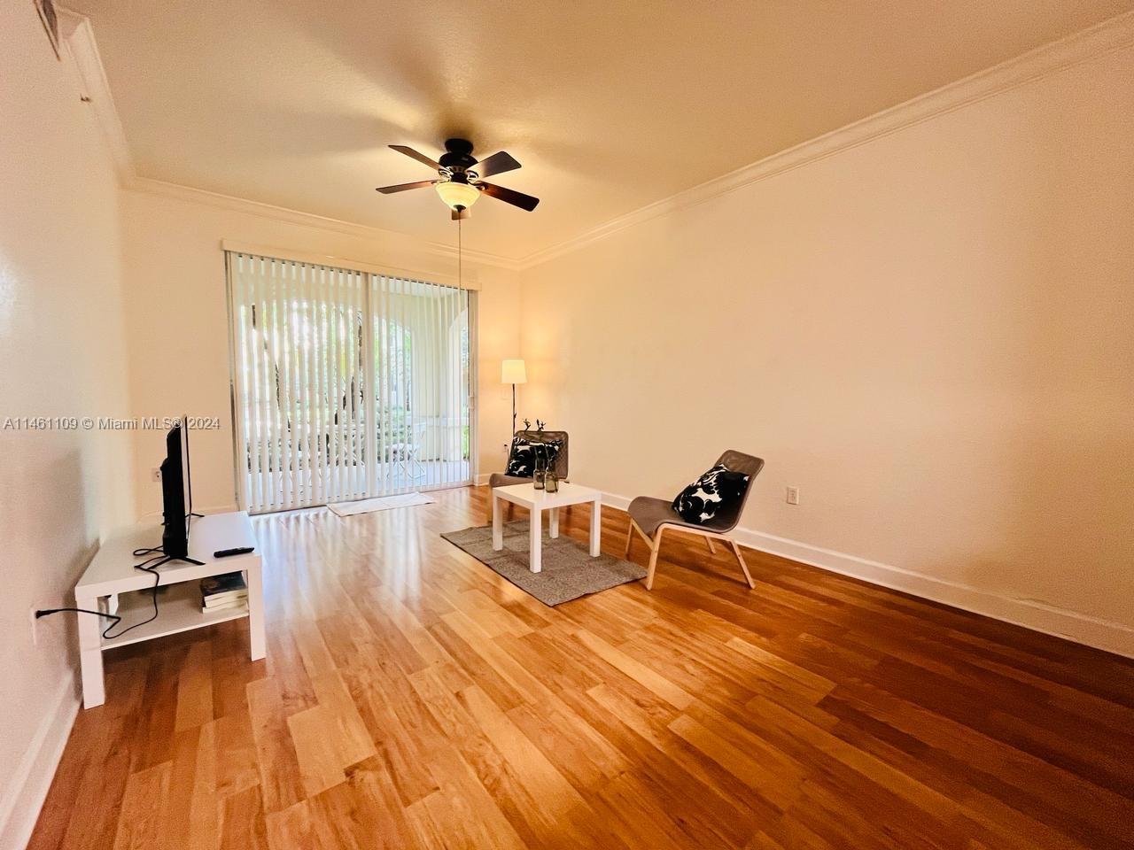 1121 Renaissance Way, Unit 1121 Boynton Beach, FL 33426 - Photo 8 of 29 a living room with furniture and a wooden floor
