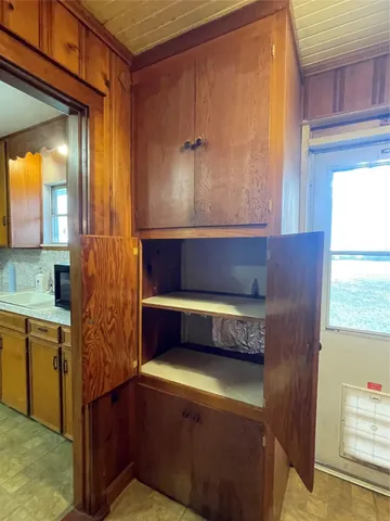 a kitchen with a wooden cabinets and a stove top oven
