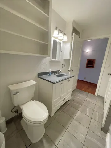 a bathroom with a sink a toilet and mirror