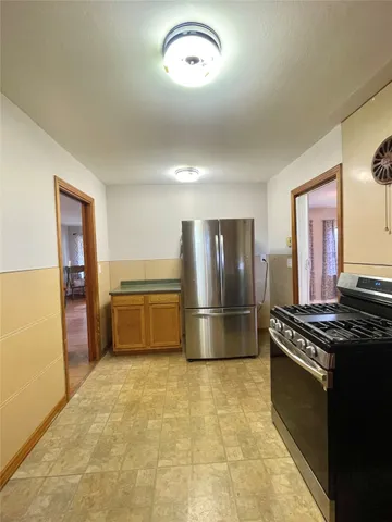 a kitchen with stainless steel appliances a refrigerator a stove a sink and dishwasher