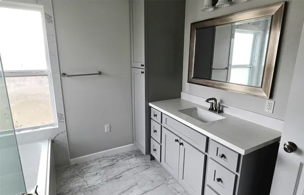 a bathroom with a sink a vanity and a mirror