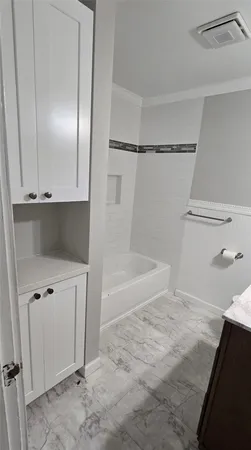 a bathroom with a bathtub and a shower