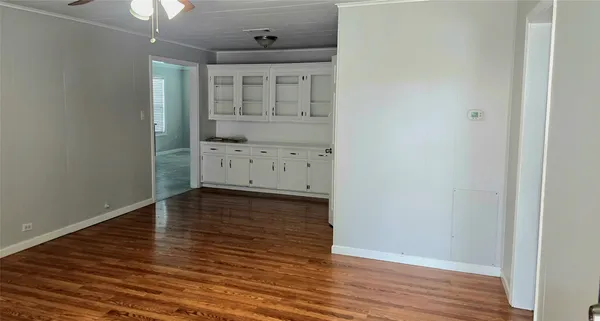 a view of a hallway with wooden floor
