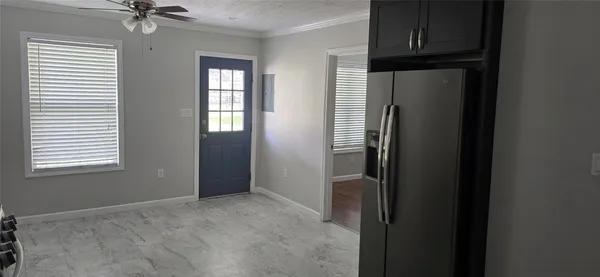 an empty room with windows and closet