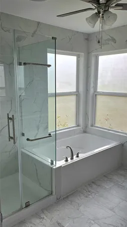 a bathroom with a tub and a shower