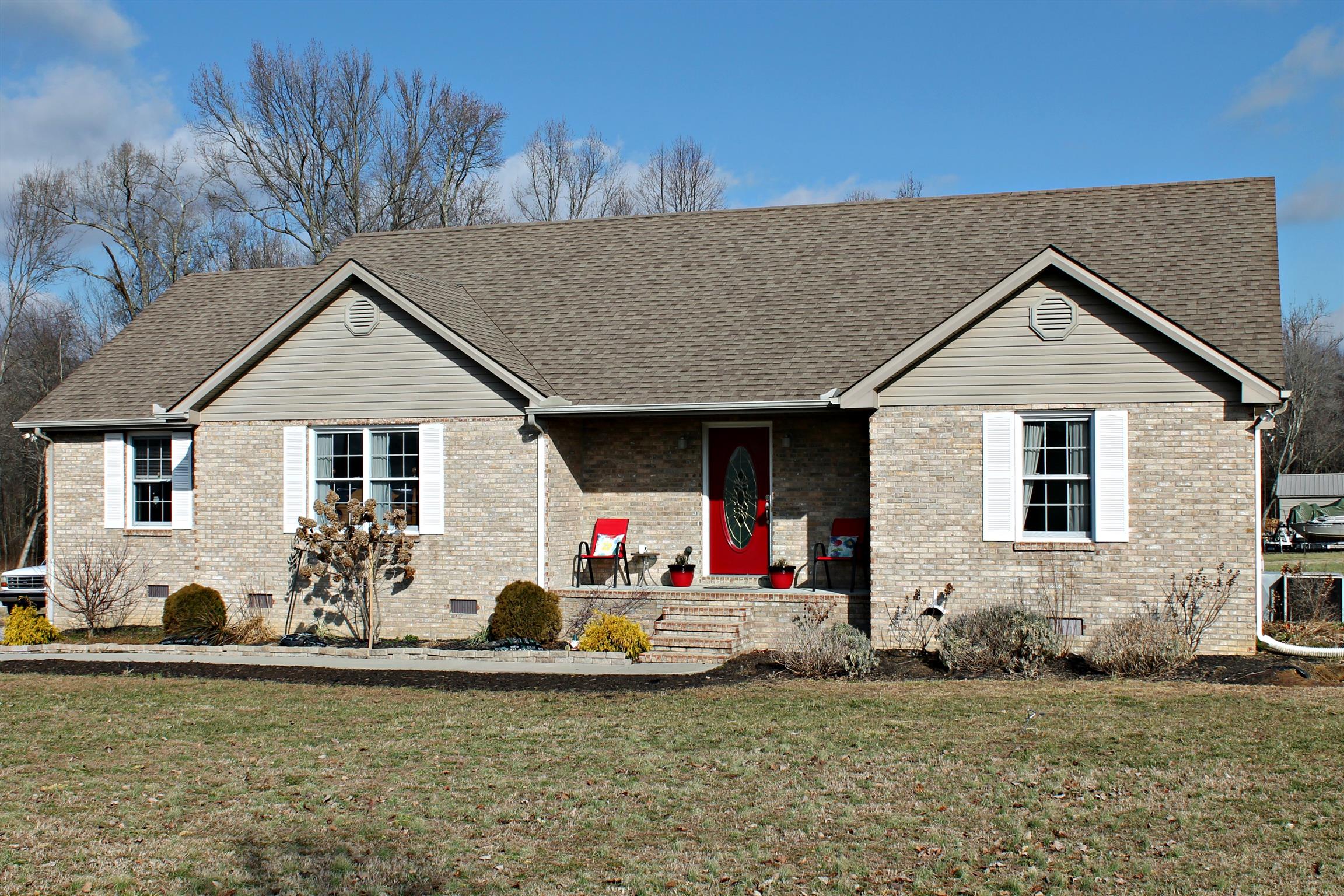 5037 Asbury Road Manchester, TN 37355 - Photo 1 of 13 a front view of a house with garden