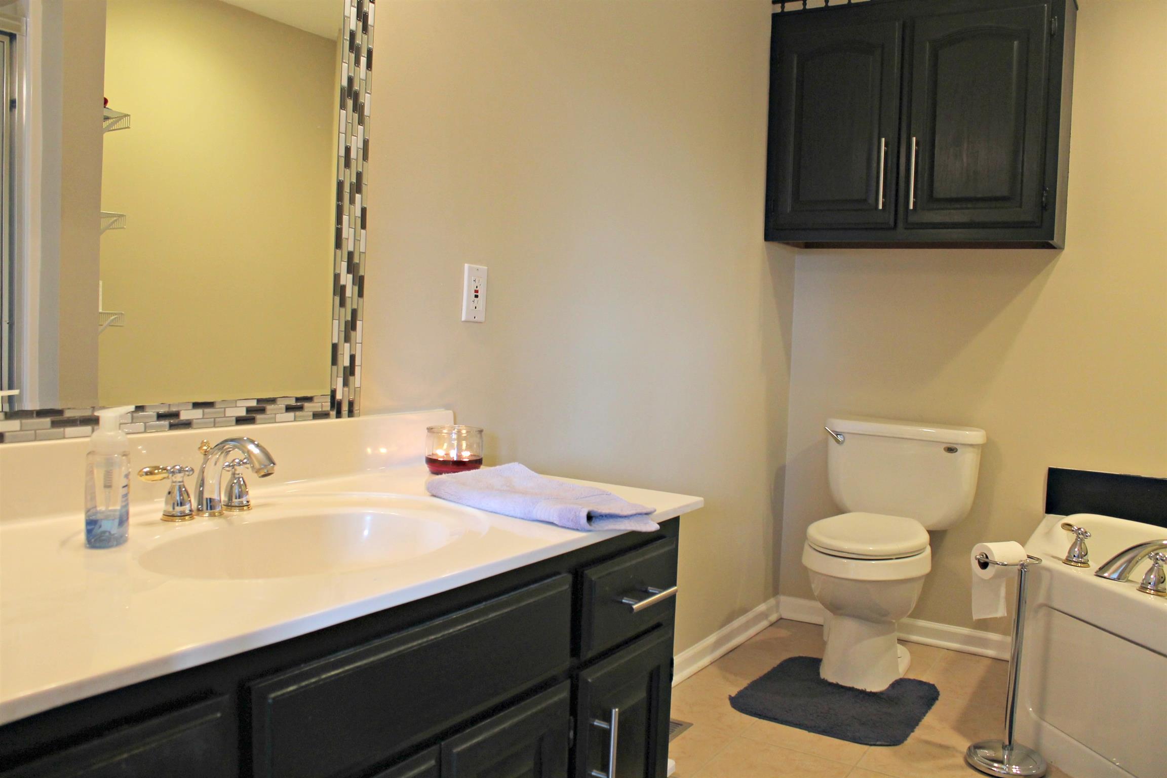 5037 Asbury Road Manchester, TN 37355 - Photo 5 of 13 a bathroom with a sink toilet and vanity