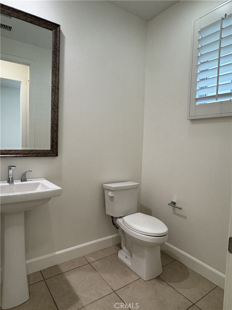 66 Diamond Flats Irvine, CA 92602 - Photo 12 of 35 a bathroom with a toilet a sink and mirror