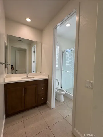 a spacious bathroom with a double vanity sink toilet and a shower