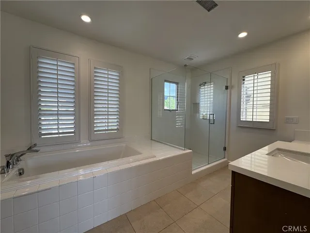 a bathroom with a tub sink and mirror