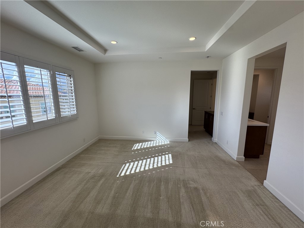 66 Diamond Flats Irvine, CA 92602 - Photo 20 of 35 a view of an empty room with wooden floor and a window
