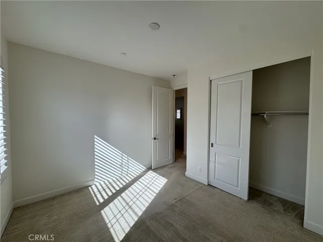 a view of a room with wooden floor and cabinet