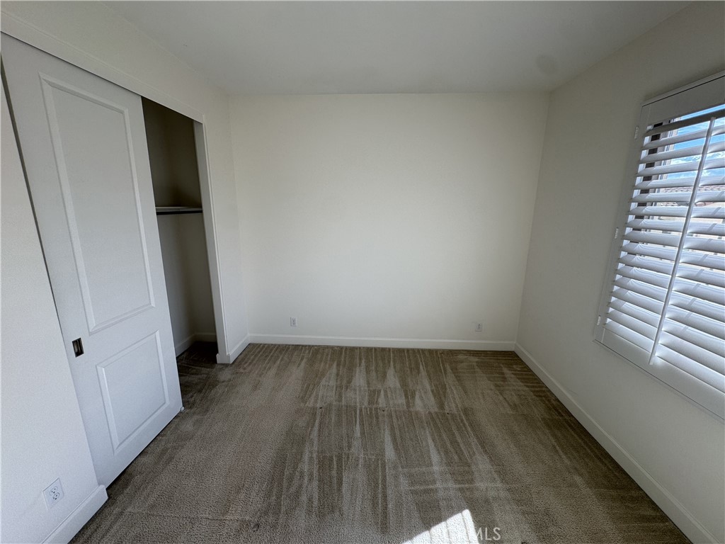 66 Diamond Flats Irvine, CA 92602 - Photo 25 of 35 an empty room with wooden floor and white walls