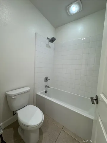 a bathroom with a toilet and a bath tub