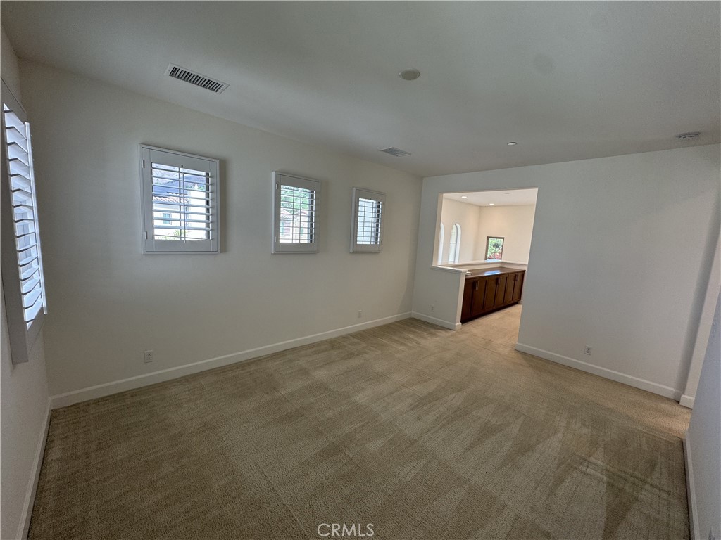 66 Diamond Flats Irvine, CA 92602 - Photo 31 of 35 an empty room with windows and cabinet