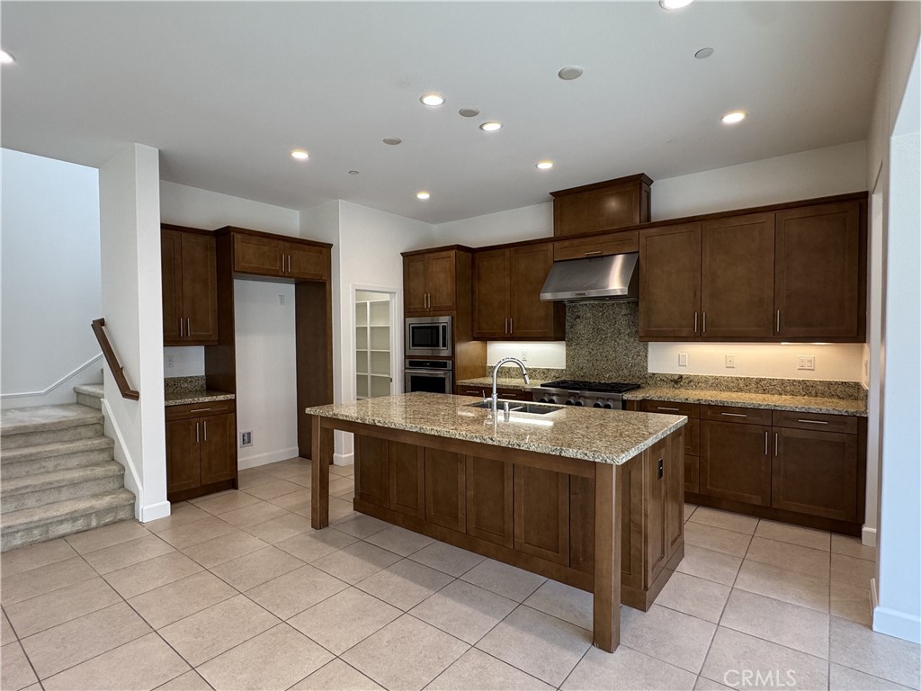 66 Diamond Flats Irvine, CA 92602 - Photo 5 of 35 a kitchen with stainless steel appliances granite countertop a sink and a stove