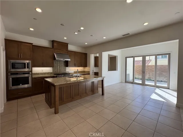 a large kitchen with stainless steel appliances lots of counter top space