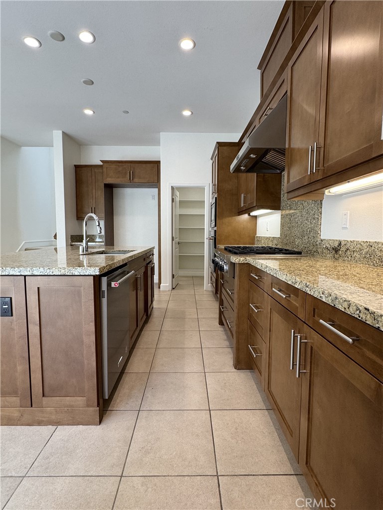 66 Diamond Flats Irvine, CA 92602 - Photo 10 of 35 a large kitchen with stainless steel appliances granite countertop a large counter top and a stove